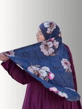 A handmade hijab featuring a dark gray base with intricate floral patterns in soft pink, cream, and burgundy tones, elegantly draped to showcase its lightweight, non-slip fabric and refined design.
