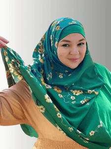 A vibrant emerald green hijab adorned with delicate yellow and white floral patterns, elegantly draped to highlight its soft, flowy fabric. The hijab offers a refreshing, nature-inspired design perfect for brightening up any outfit.