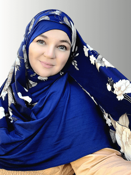 
An instant double-loop hijab in deep navy blue with soft cream floral accents, designed for easy, pin-free styling, shown on a model wearing a matching navy-blue dress. Perfect for effortless elegance.Maida's Hijab World 
