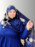 
An instant double-loop hijab in deep navy blue with soft cream floral accents, designed for easy, pin-free styling, shown on a model wearing a matching navy-blue dress. Perfect for effortless elegance.
