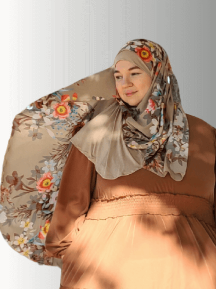 Blossom Whisper Veil, an elegant hijab from the Luxe Harmony Collection, featuring earthy cream tones with delicate pink and white floral accents, crafted with a chiffon overlay and jersey base for instant, effortless styling.