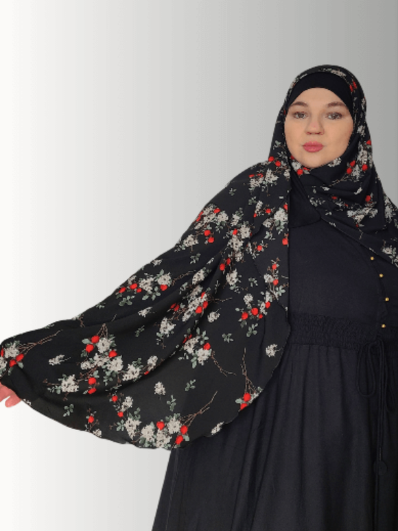  A vibrant handmade hijab featuring red and white floral designs on a black background, part of the Luxe Harmony Collection. The lightweight jersey fabric ensures a soft, breathable, and comfortable fit for all-day wear.