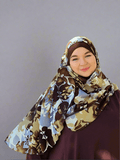 Woman smiling  while wearing a golden brown hijab with deep autumn shades of cream brown colors 